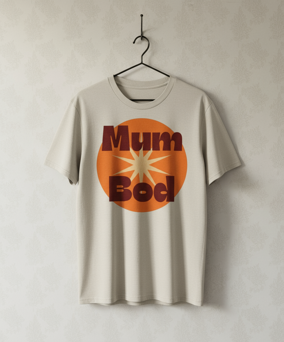 Beige t-shirt with 'Mum Bod' graphic on a plain background